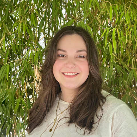 Leah Hogue smiling in front of a tree